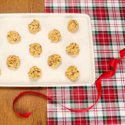 Cookie Dough on a tray with a red ribbon on a holiday background
